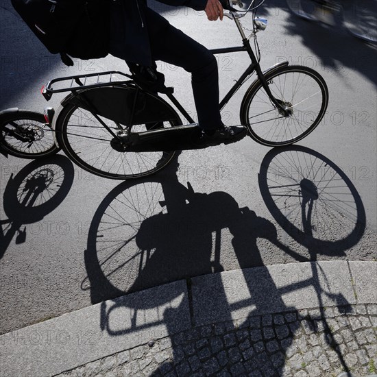 Symbolic photo on the subject of cycling in the city. Cyclists ride on the bicycle lane in Linienstrasse in Berlin Mitte. Berlin