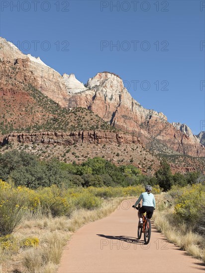 Woman riding mountain bike on Pa'rus Trail in Zion Canyon