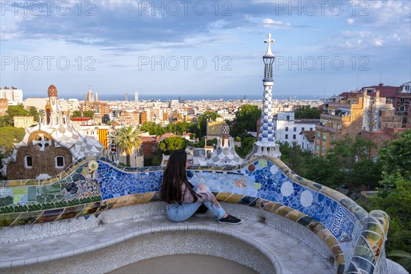 Tourist sitting on bench with colourful mosaic