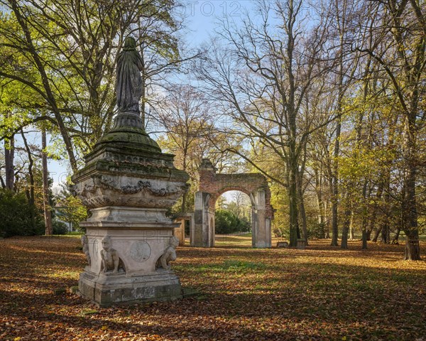 Sculpture The Veiled Image of Sais and Roman Ruin Arch in the Luisium Park in Autumn