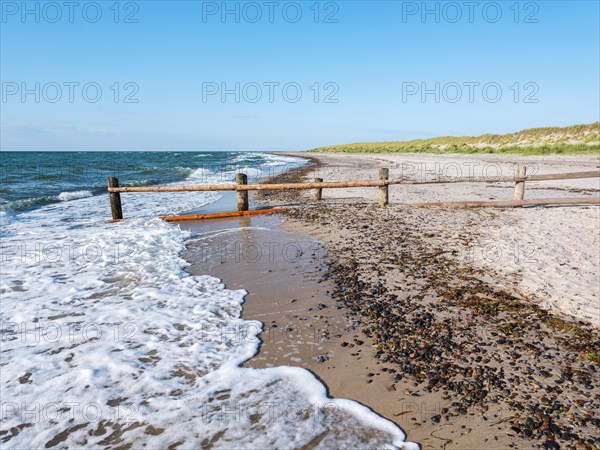 Fence on the beach of the Baltic Sea as the border of the closed-off core zone of the National Park Vorpommersche Boddenlandschaft