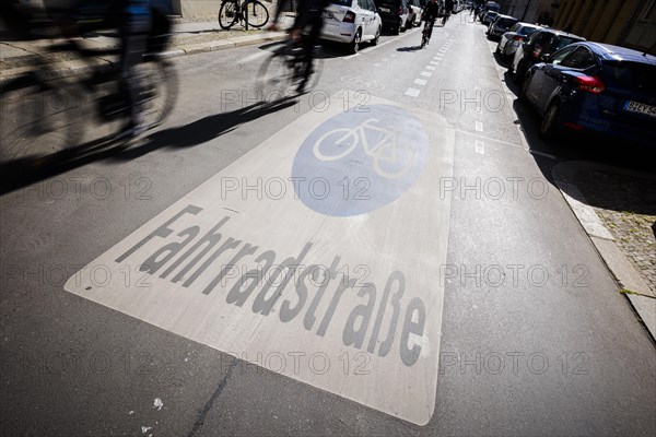 Symbolic photo on the subject of bicycle lanes in the city. Cyclists ride on the bicycle street in Linienstrasse in Berlin Mitte. Berlin