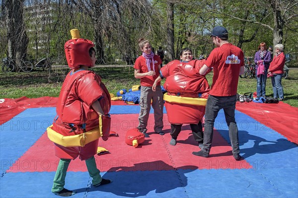 Children playing as sumo wrestlers in springtime Luitpoldpark