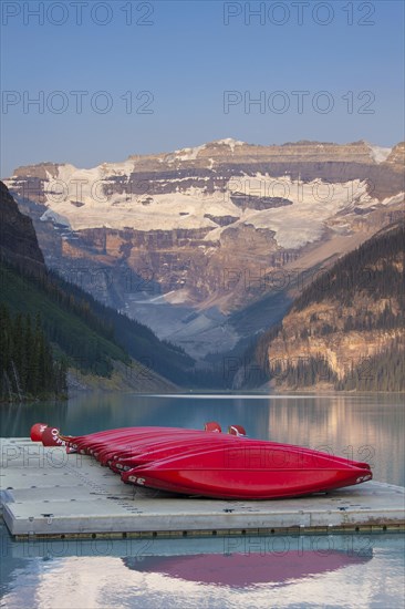 Red canoes at glacial Lake Louise with Victoria glacier