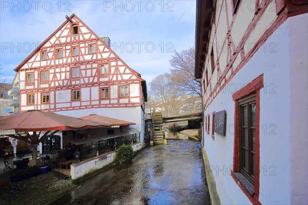 Half-timbered house Lochmuehle with mill wheel on the Grosse Blau stream in Gerbergasse