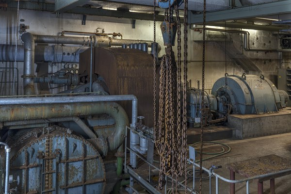 Chains from a pulley block in the pump room of a former paper factory