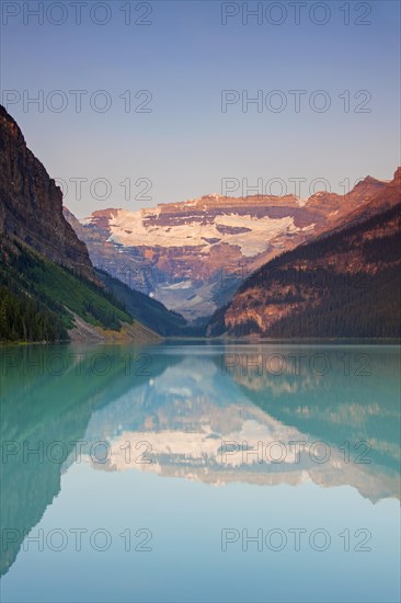 Glacial Lake Louise with Victoria glacier and mountains reflected in emerald water