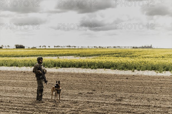 A soldier of the German Armed Forces with a mission dog