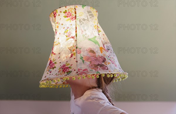 Girl with a lampshade on her head