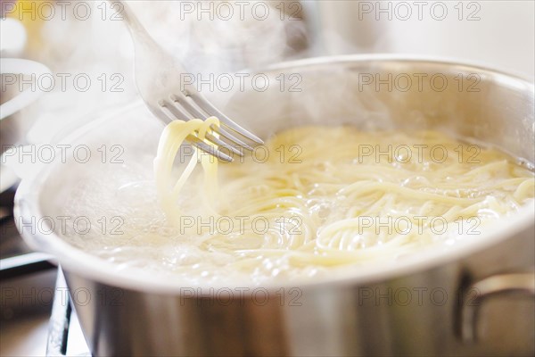 Symbol photo on the subject of cooking pasta. Cooking spaghetti in a saucepan. Berlin