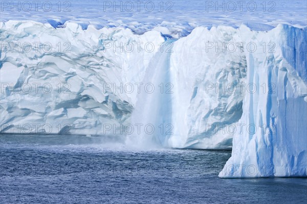 Waterfalls at edge of the Brasvellbreen glacier from the ice cap Austfonna debouching into the Barents Sea