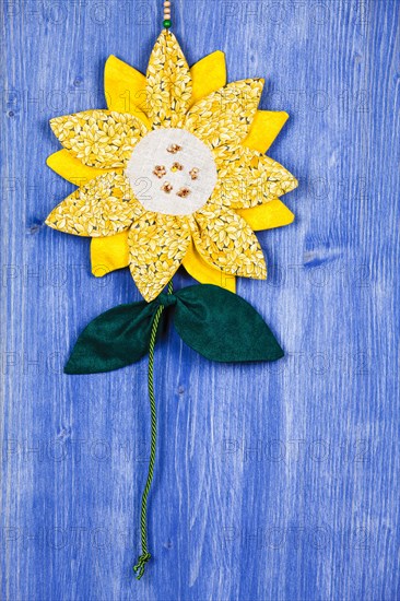 Fabric sunflower on blue background