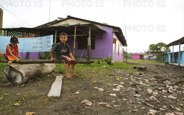 Children playing among colourful wooden houses in Tortuguero