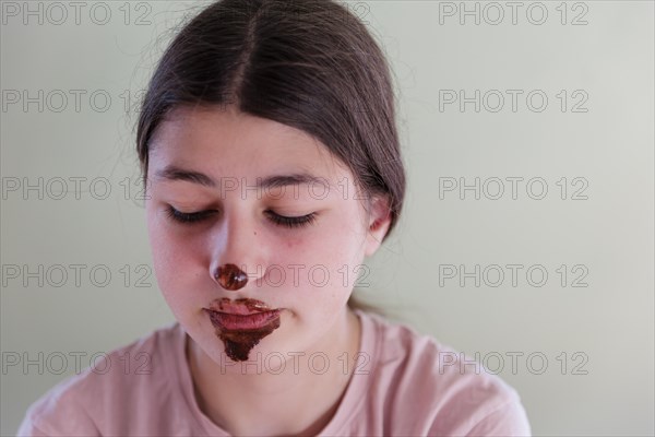 Girl with a chocolate-smeared mouth