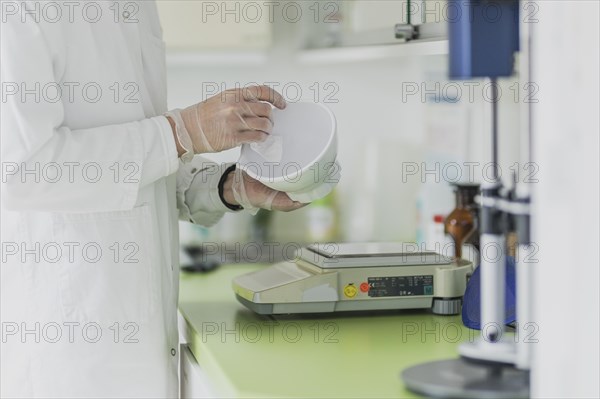 A prescription worker cleans a fan tray