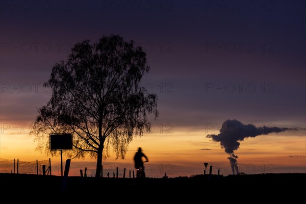 The Schwarze Pumpe coal-fired power plant looms in the evening twilight near Ober-Prauske