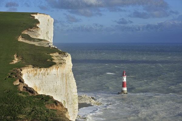 View over the eroded white chalk cliffs and lighthouse at Beachy Head