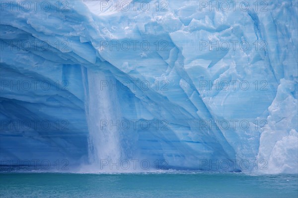 Waterfall at edge of the Brasvellbreen glacier from the ice cap Austfonna debouching into the Barents Sea