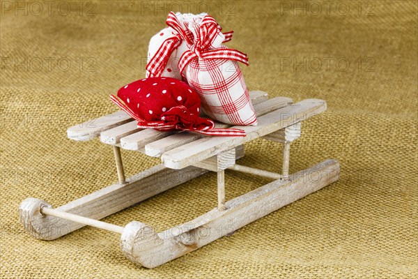 Three little bags on a wooden sledge