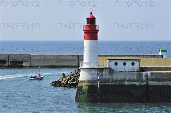 Lighthouse and sailing boat leaving the Guilvinec port