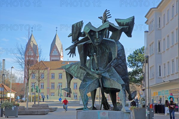 Fools' Fountain with sculptures Witch and Witch's Broom by Willi Dorn 1964 with Holy Trinity Church