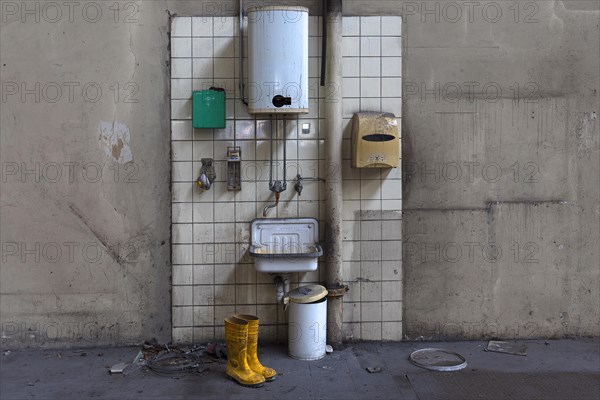 Hand basin with instantaneous water heater in a factory hall in a former paper factory