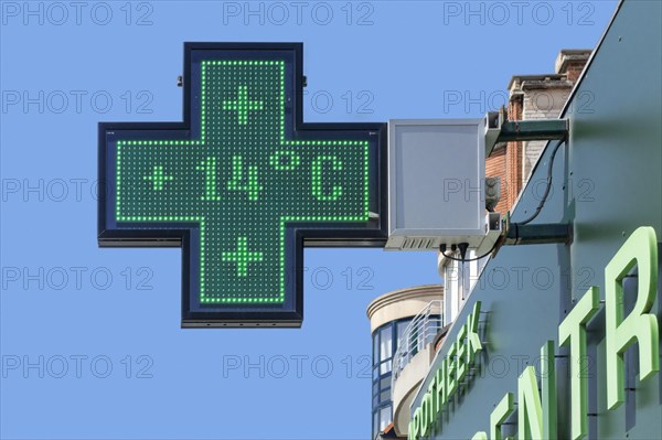 Thermometer in pharmacy screen sign displays extremely warm temperature of 14 degrees Celsius