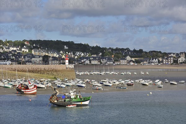 Fishing boats and sailing boats in the harbour of Erquy at low tide