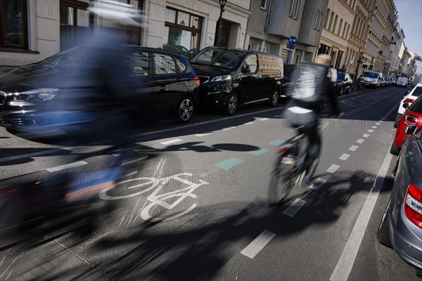 Symbolic photo on the subject of bicycle lanes in the city. Cyclists ride on the bicycle street in Linienstrasse in Berlin Mitte. Berlin