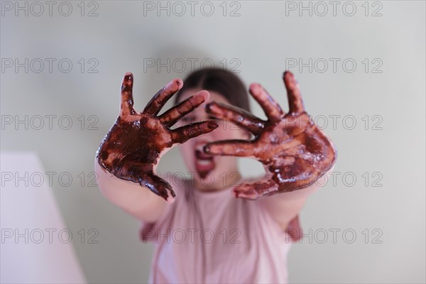 Girl with a chocolate-smeared mouth