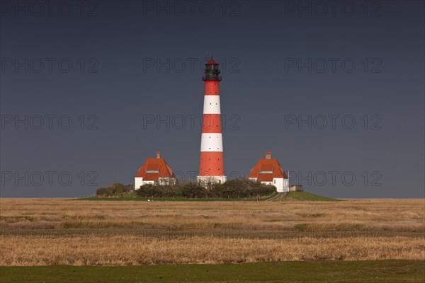 Dark rain cloud rolling in over lighthouse Westerheversand at Westerhever