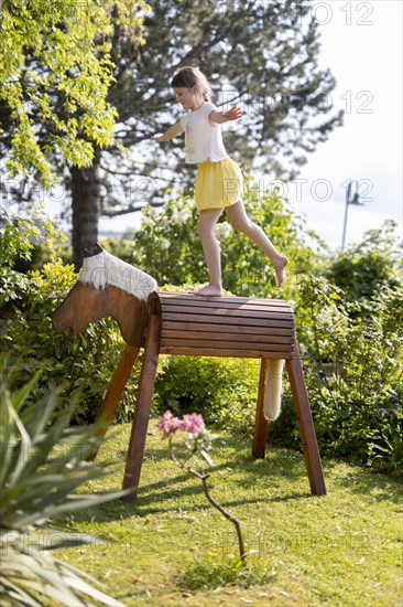 Girl gymnastics on a wooden horse