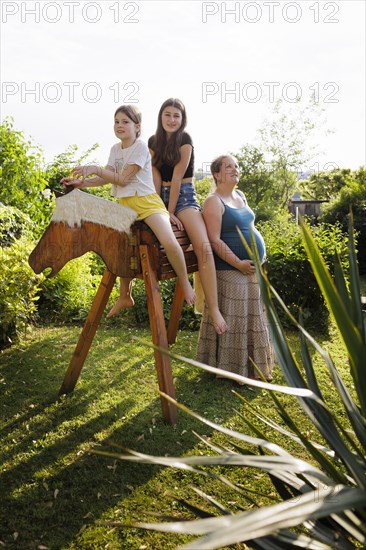 Pregnant mother with two daughters