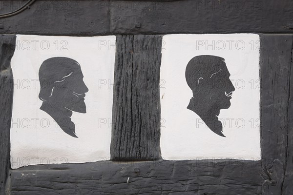 Two men's hairstyles at the half-timbered house of the hairdresser's salon