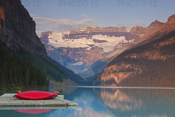 Red canoes at glacial Lake Louise with Victoria glacier