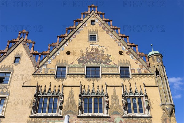 Upper part of the Ulm Town Hall with ornate windows with six elector figures and facade with murals