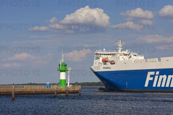 Ro-ro ferry Finnmill from Finnlines passing lighthouse Travemuende Nordmole