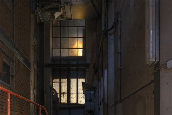 Window to the staircase in the powerhouse of a former paper factory