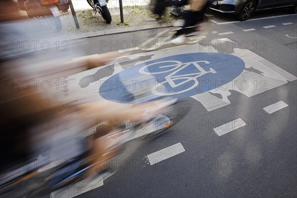 Symbolic photo on the subject of bicycle lanes in the city. Cyclists ride on the bicycle street in Linienstrasse in Berlin Mitte. Berlin