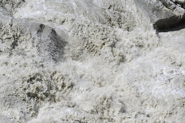 Mountain stream in the Alps with meltwater from a glacier