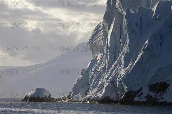 Crumbling wall of ice from glacier at Antarctica