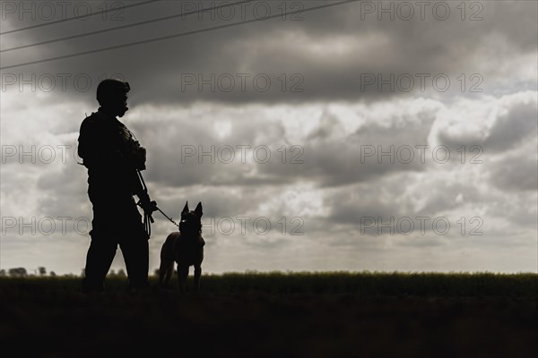 A soldier of the German Armed Forces with a mission dog