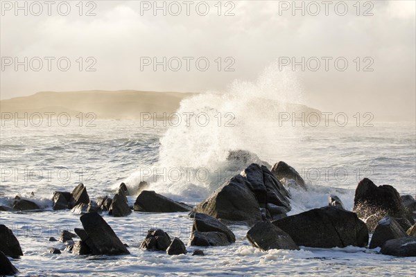 Atmospheric coastal landscape at sunrise on a rocky beach near Reiff on the west coast of Scotland