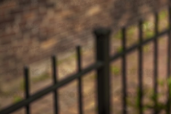 Iron gate and a brick wall