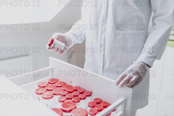 A prescription worker takes a TopTec Kruke from a drawer