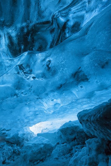 Blue ice mixed with volcanic ash in ice cavern inside Breidamerkurjokull