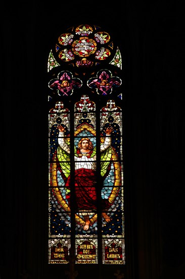 Stained glass window with Jesus at the blessing with biblical quote : I am the way and the truth and the life