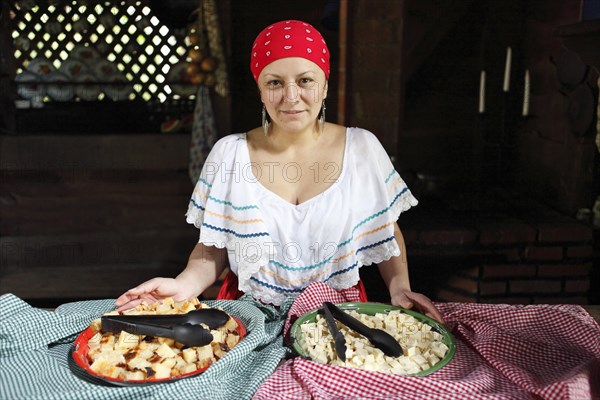 Costa Rican woman with corn pudding tamale asado and homemade cheese CaseroI