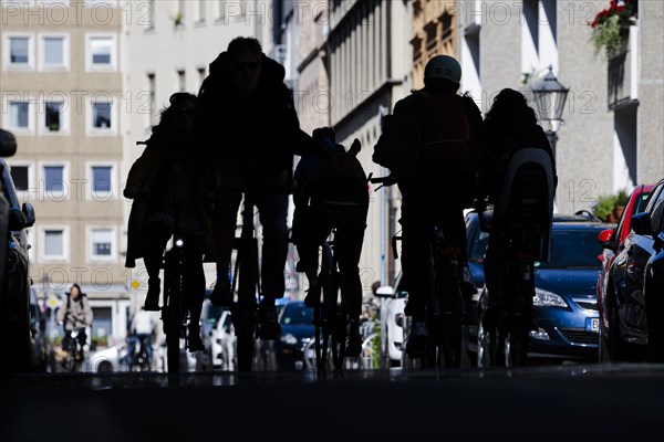 Symbolic photo on the subject of bicycle lanes in the city. Cyclists ride on the bicycle street in Linienstrasse in Berlin Mitte. Berlin