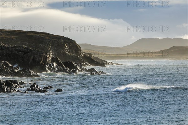 Atmospheric light on the stormy rocky coast of western Scotland